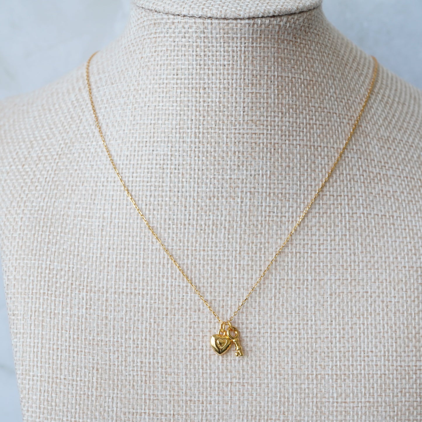 Gold key and lock charm necklace