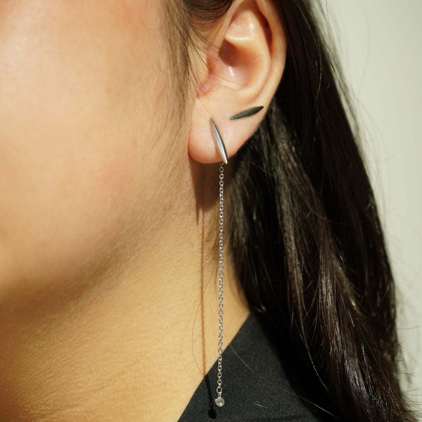 Sculptural stud and delicate chain earrings