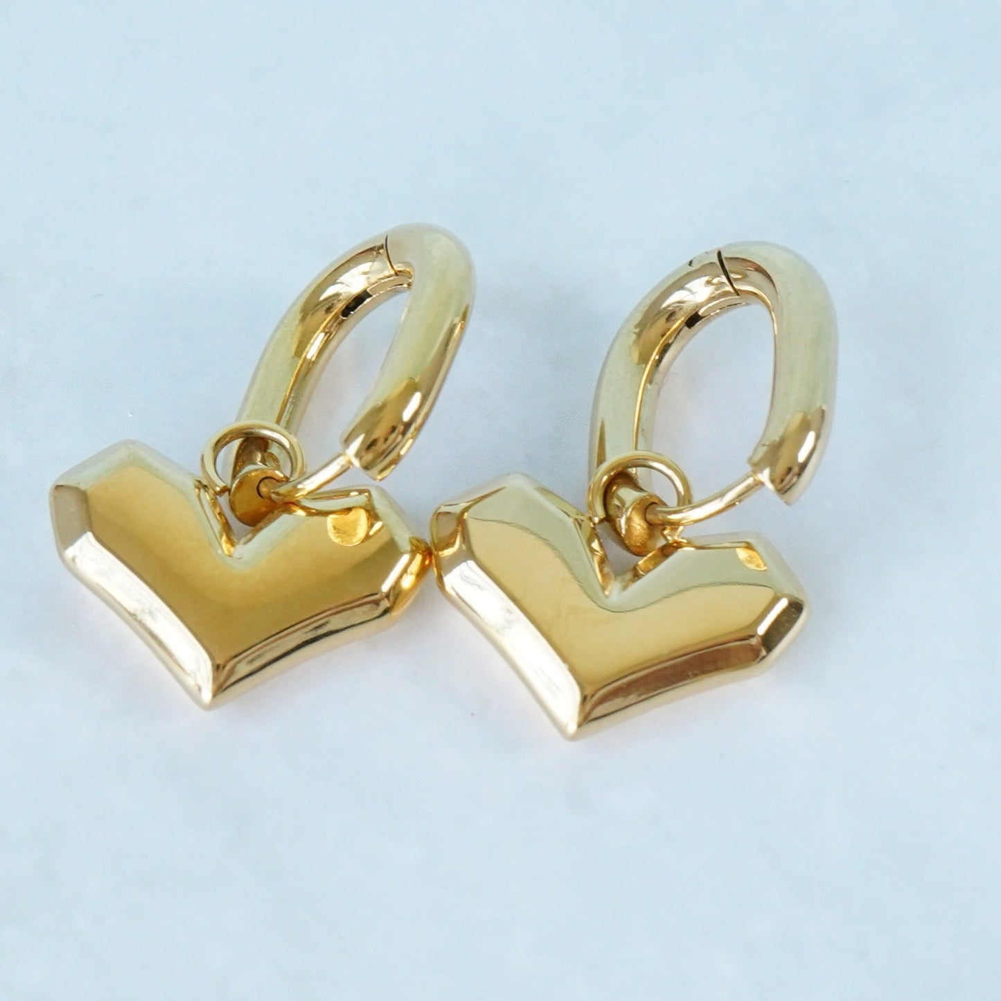 Golden hoops with removable heart charm earrings